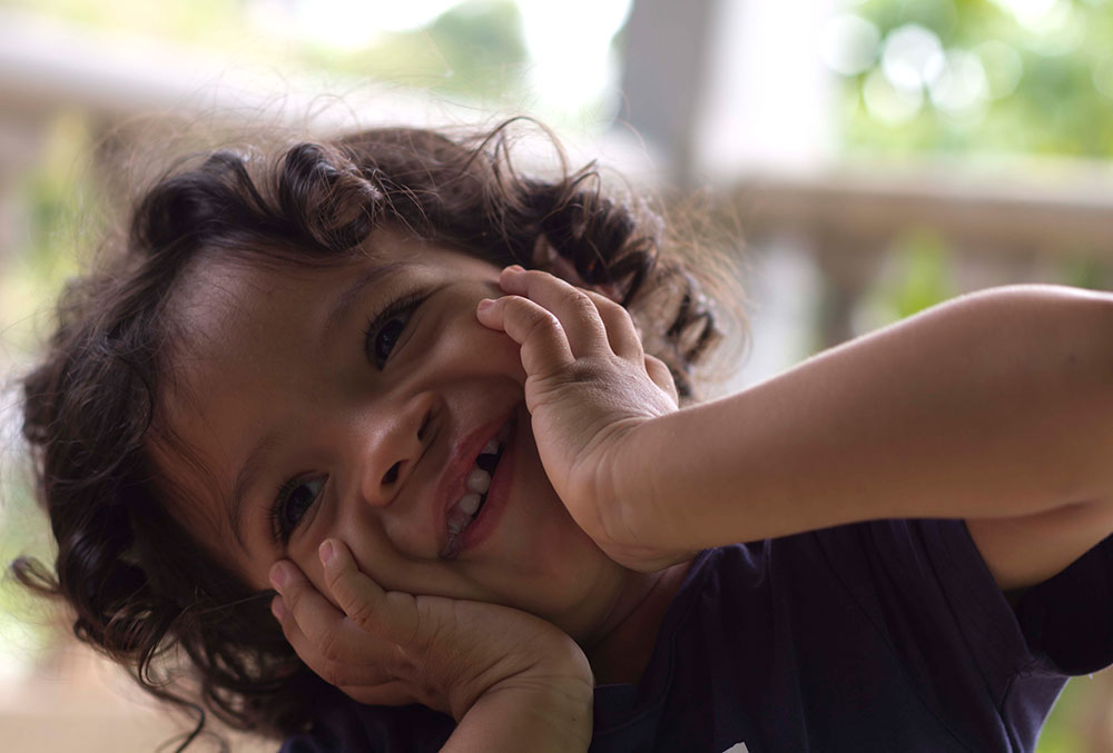 Marco smiling with his hands on his cheeks