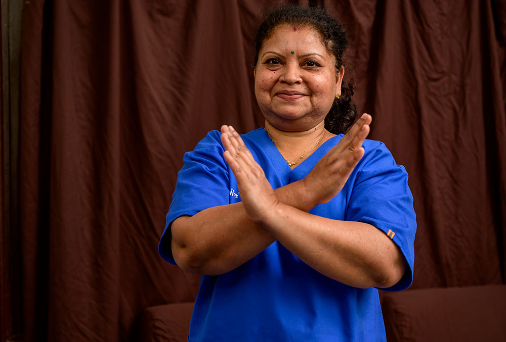 Dr. Neela crossing her arms for International Women's Day 