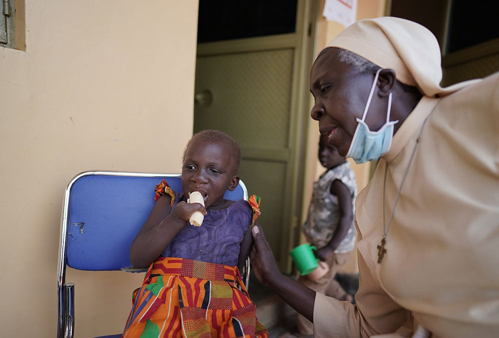 Sister Najjuka providing a cleft patient critical nutritional support