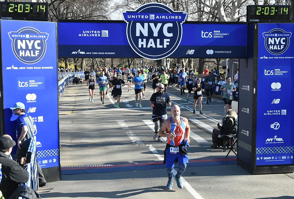 Eric crosses the finish line at the 2022 New York Half