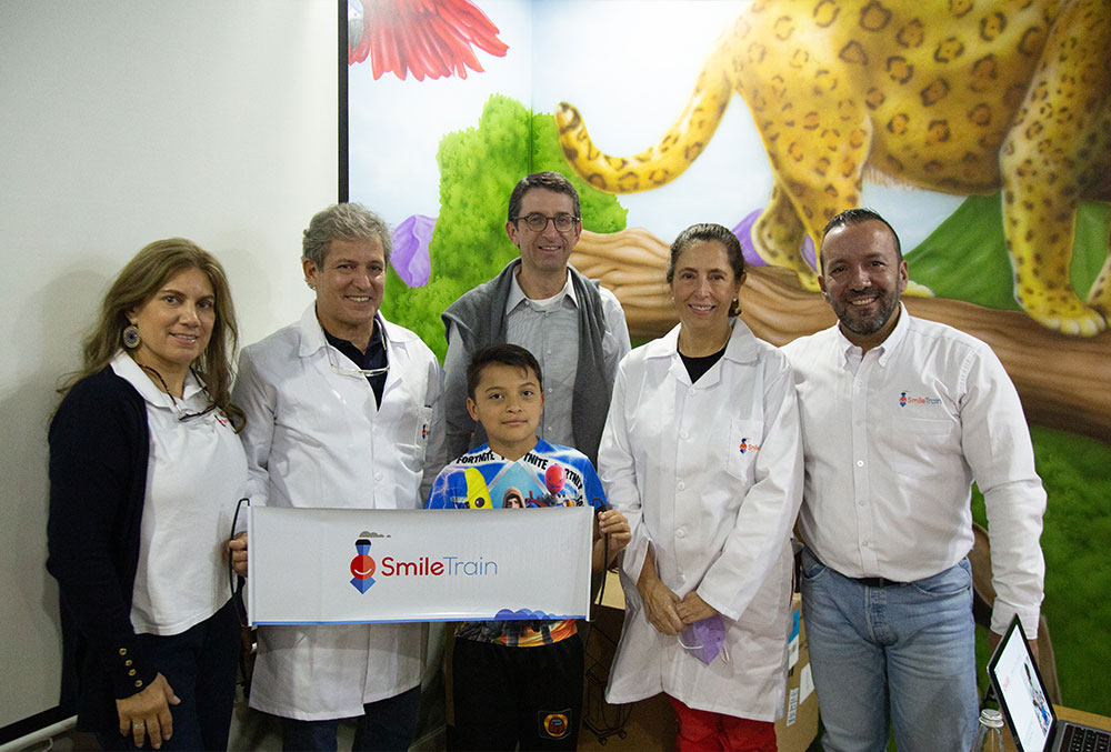 Smile Train and FISULAB staff standing with a patient