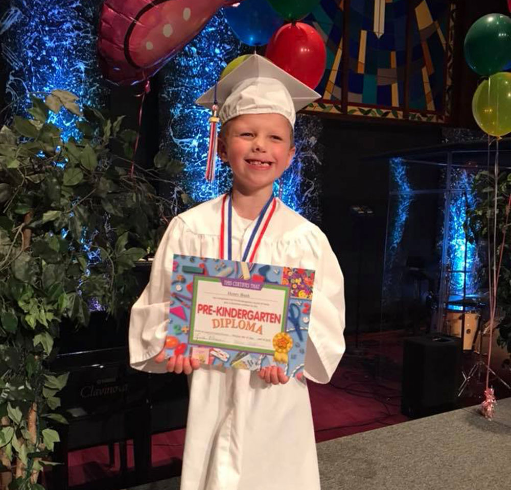 Henry smiling at his preschool graduation