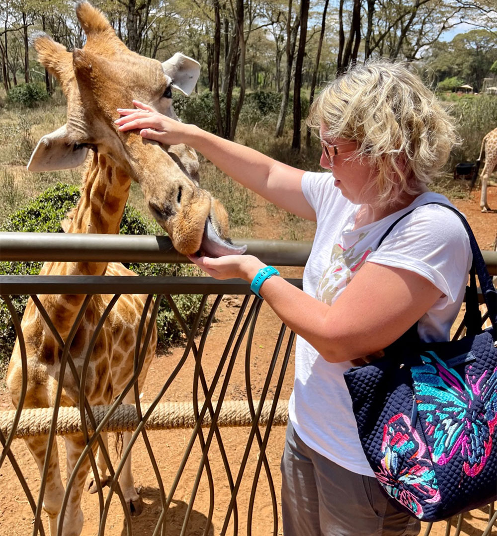 Crissy with a giraffe in Kenya