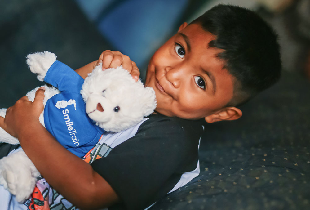 Mathias holding his Smile Train bear