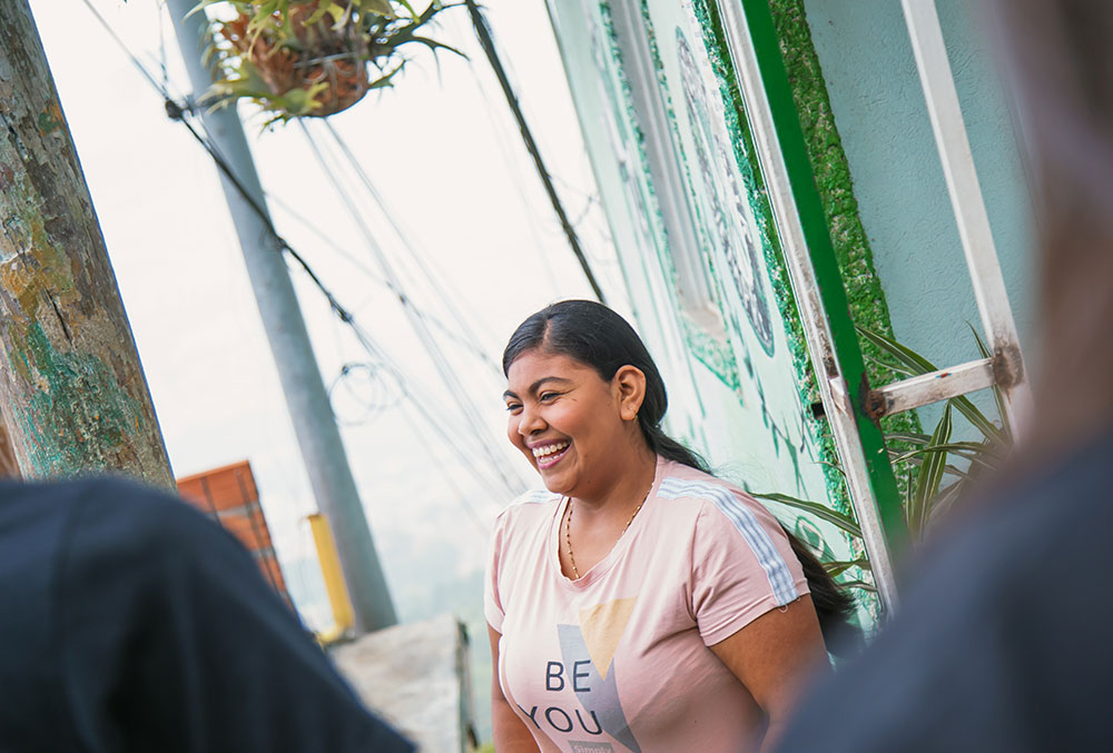 Yesica outside her home