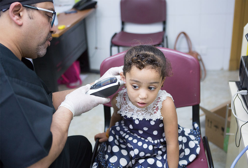 Dr, Tarek tests a patient's hearing 