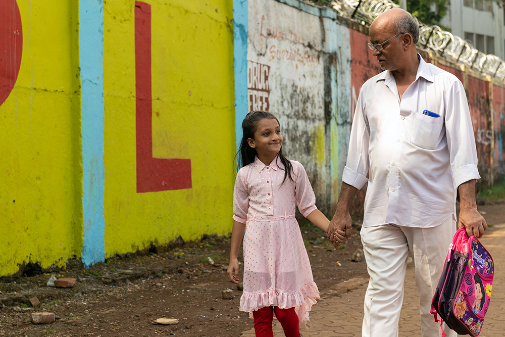 Humera walking to school with her grandfather
