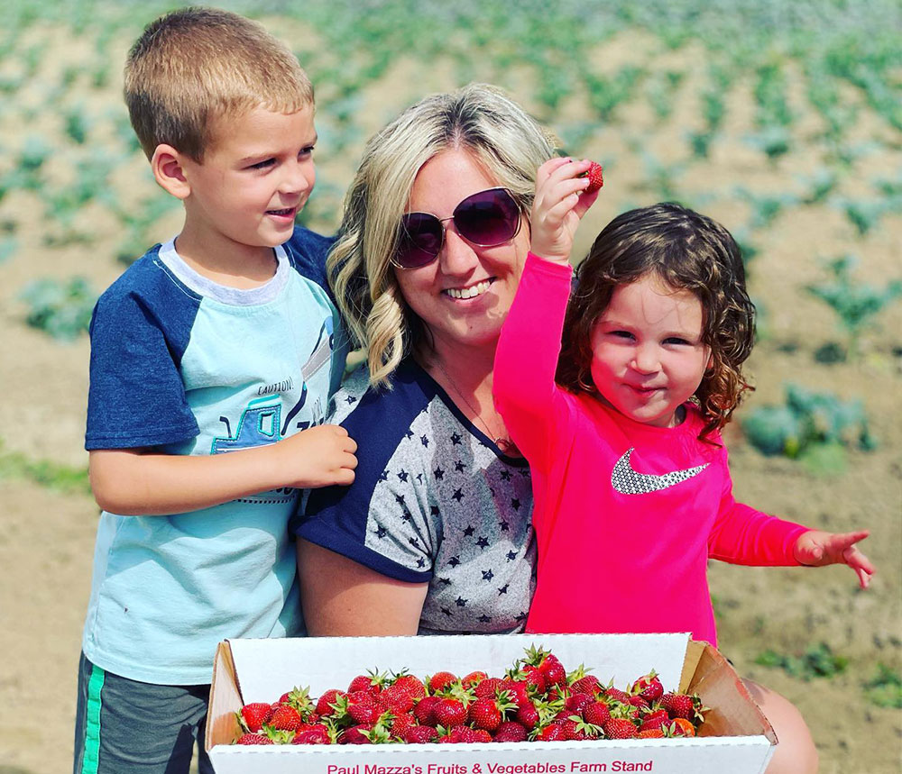 Miranda picking strawberries with her step-children