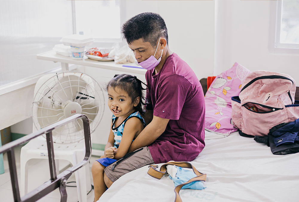 Ernie, Sr. and Ernie, Jr. share a moment before Jr.'s cleft surgery