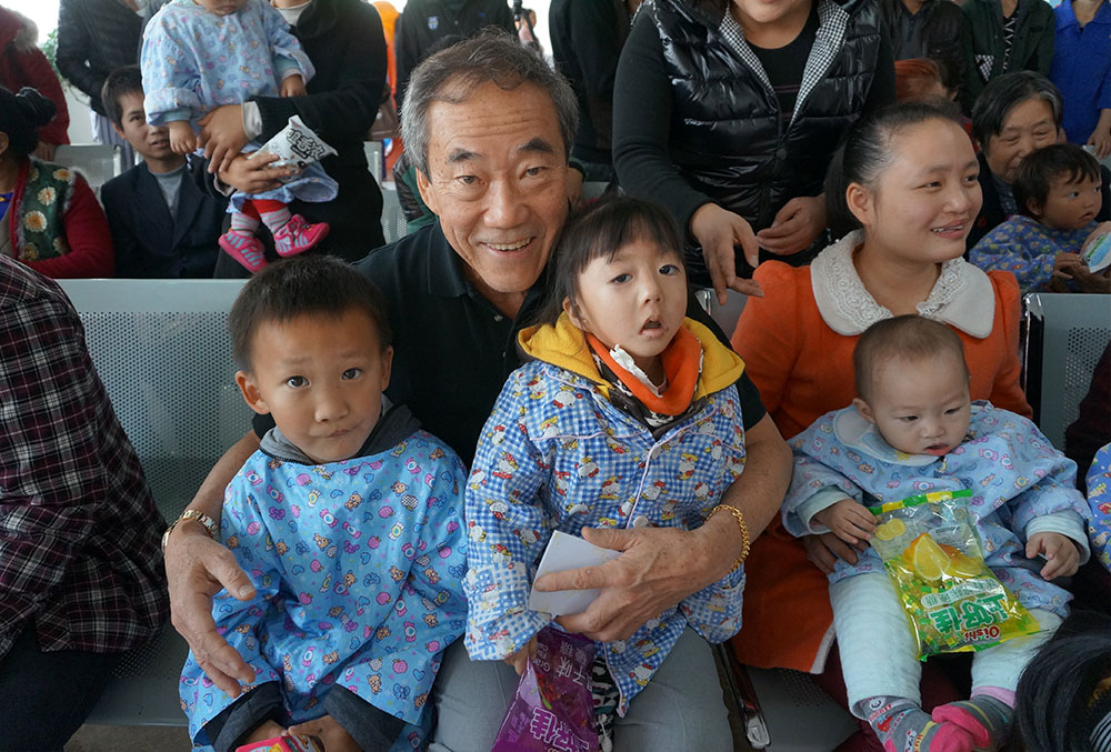 Charles B. Wang with Smile Train patients