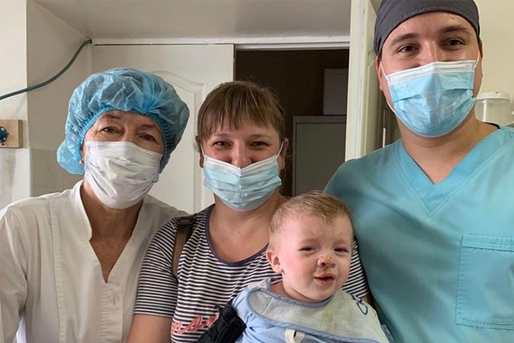 Dr. Tetruieva with a young patient and his happy family shortly after his cleft surgery