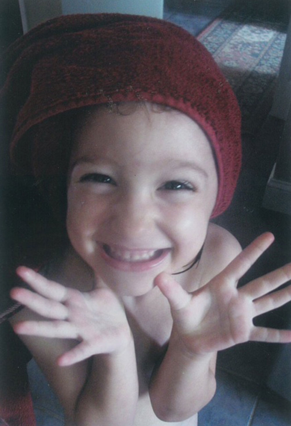 Sadie smiling with a towel on her head and holding her fingers up