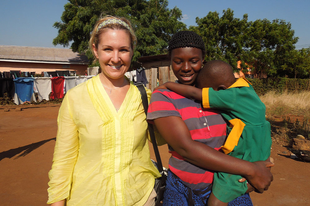 Sara with a patient and his mother on her Journey of Smiles to Tanzania