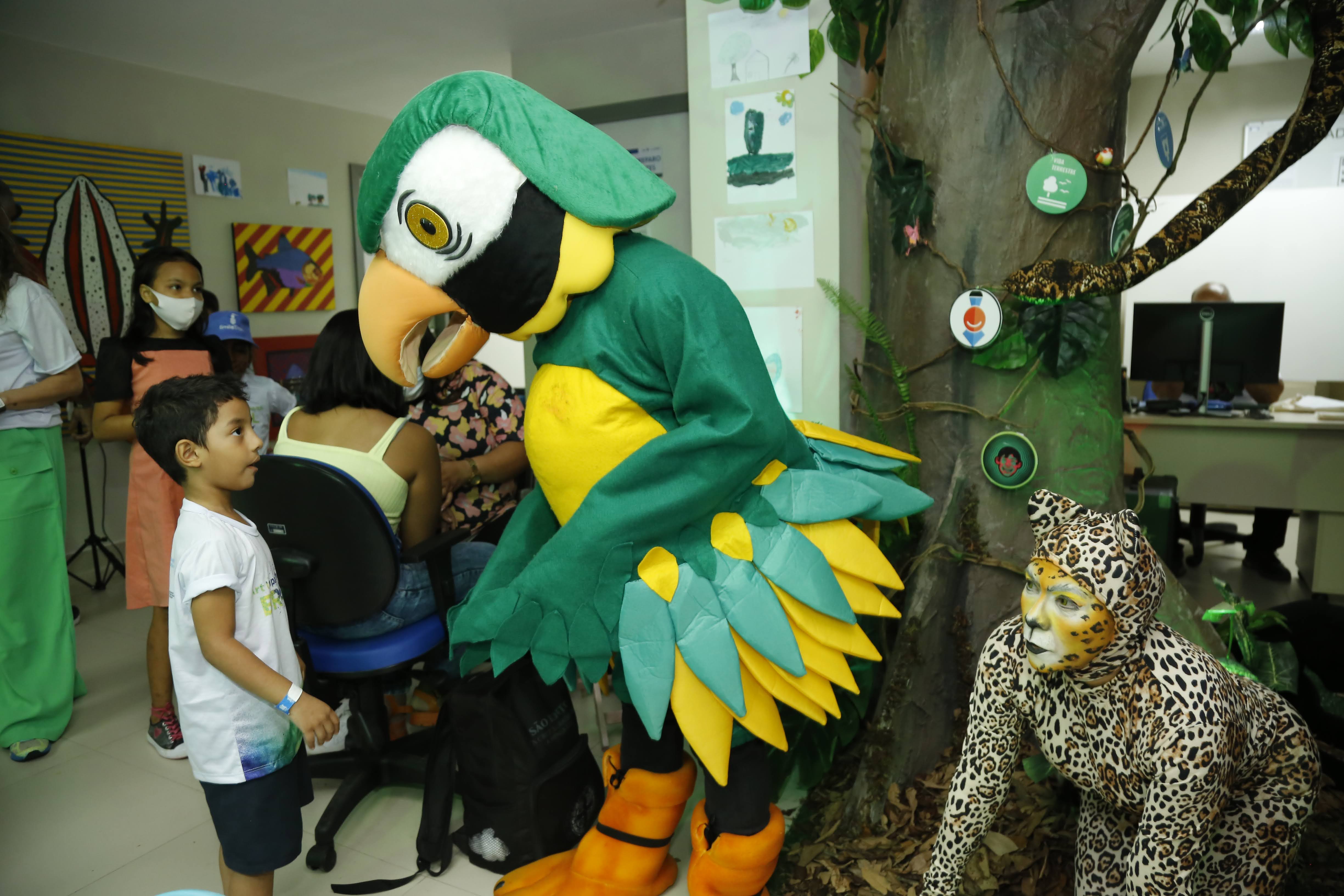 Young boy interacts with Amazonian creatures