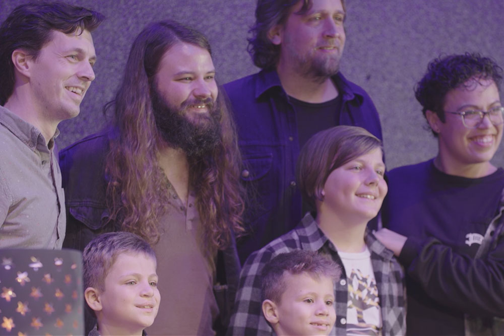 Hayes Carll and Brent Cobb smile with Daniel and his family