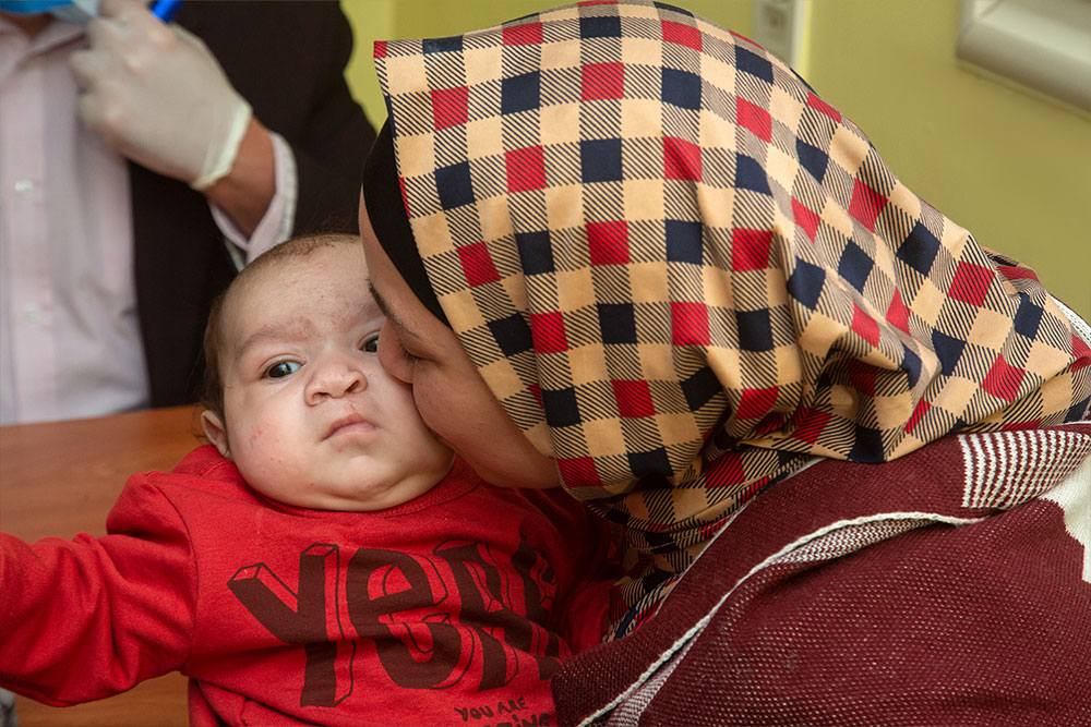 Nagla kissing Mustafa after his cleft surgery