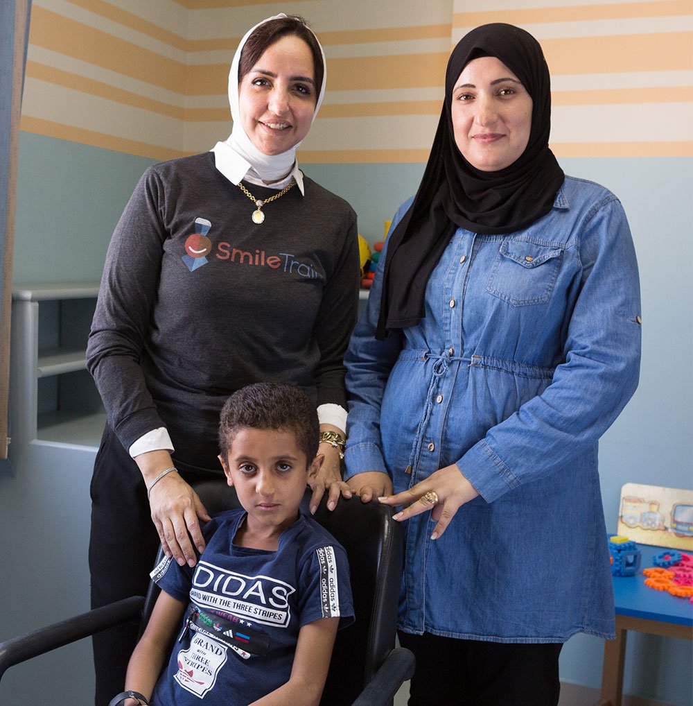 Dr. Sally with a patient and his mother