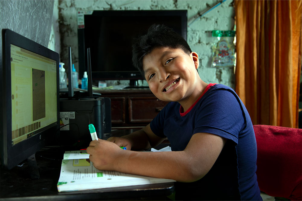 Jhon Bruce Lee smiles as he does his homework