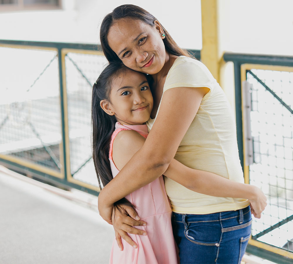 Angel and Joy smiling and hugging