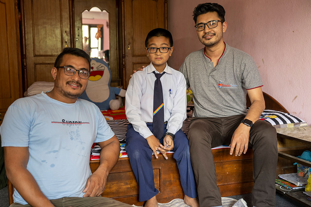 Jenious with his father, Janak, and Dr. Anoj Rajkarnikar, junior plastic surgeon at B and B Hospital