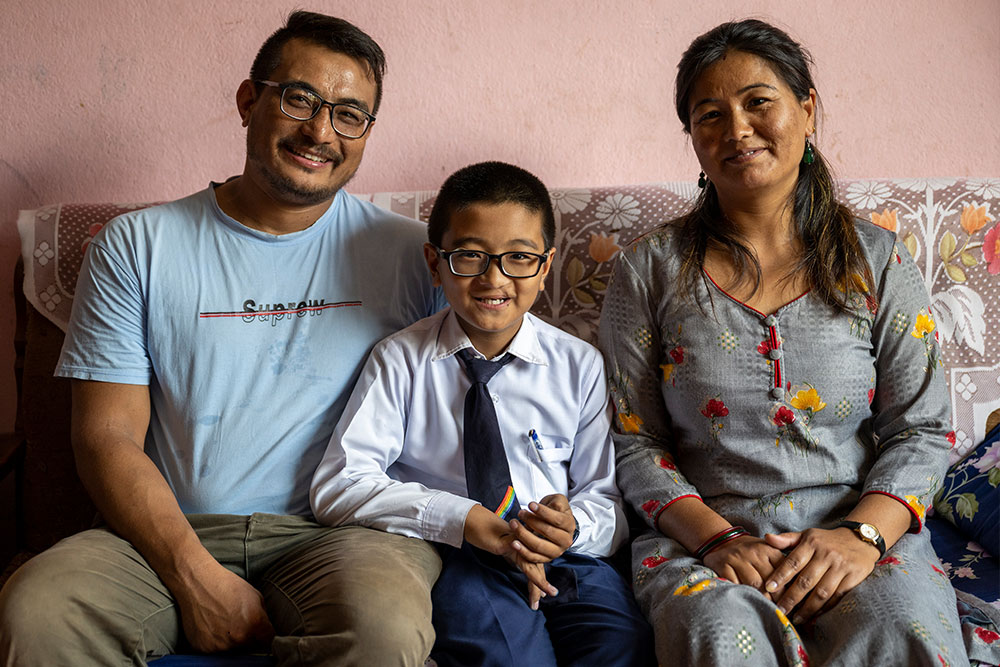 Jenious flanked by his parents Janak and Jamuna on the family couch