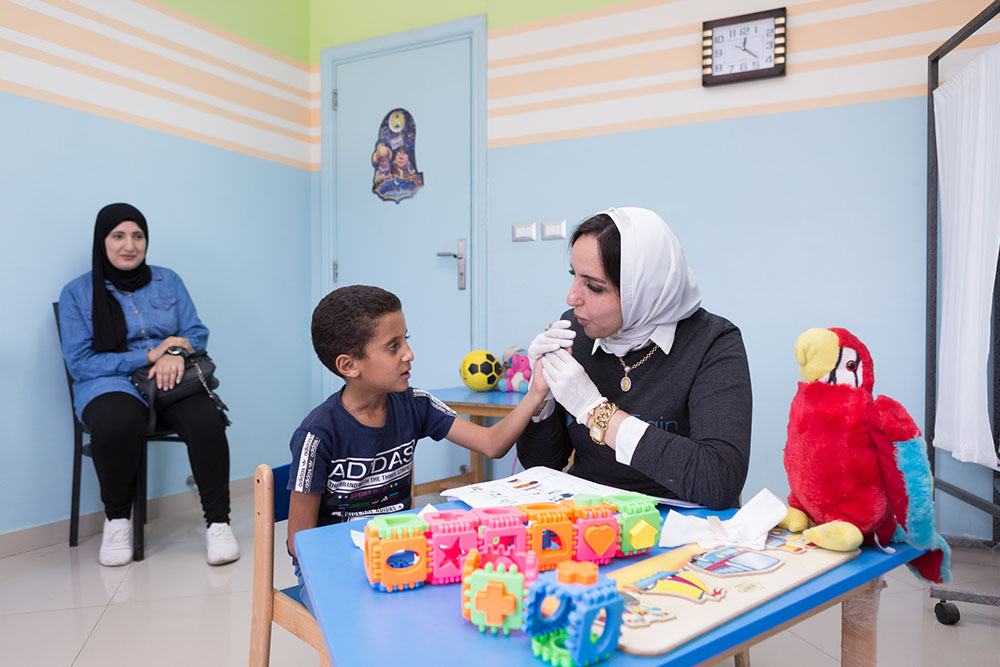 Fares at speech therapy with Dr. Sally and Nadia