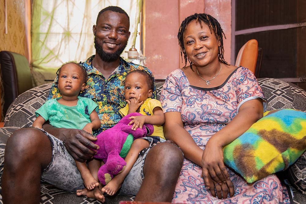 Oloye smiling with her husband and twins