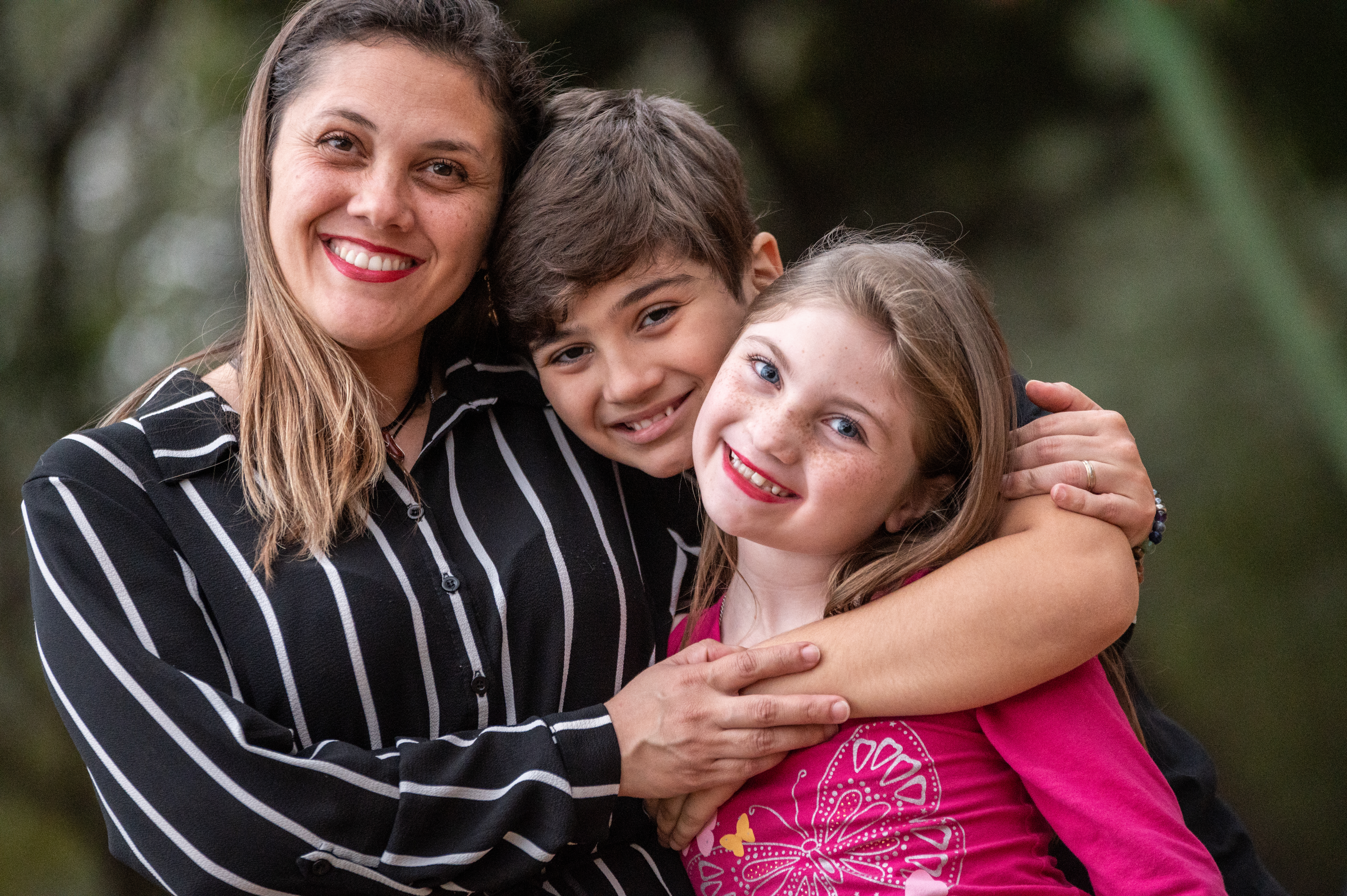 Grazi, Nilo, and Milena hugging