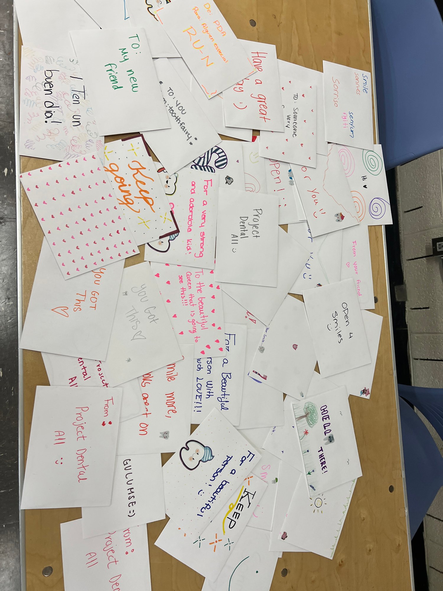 A pile of white cards decorated with words of encouragement