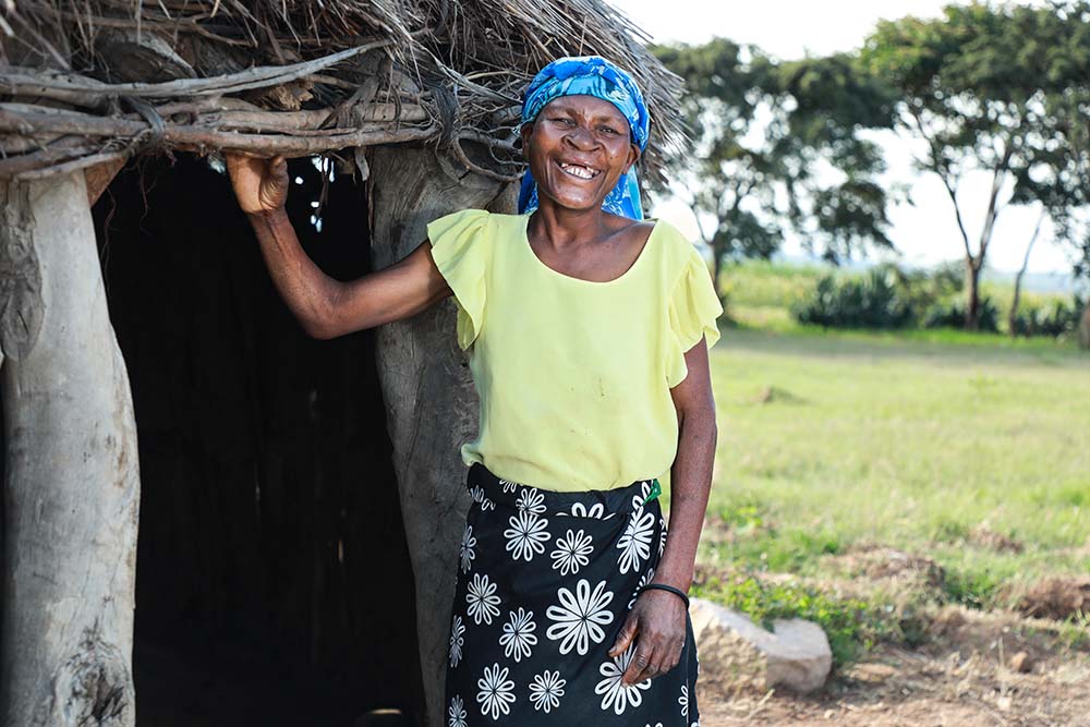 Zita standing in the doorway of her home