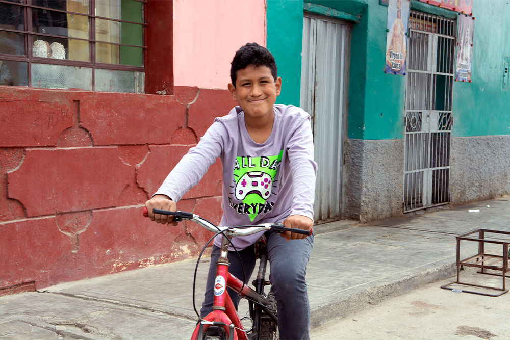 Imanol giving the camera a thumbs up on his red bike