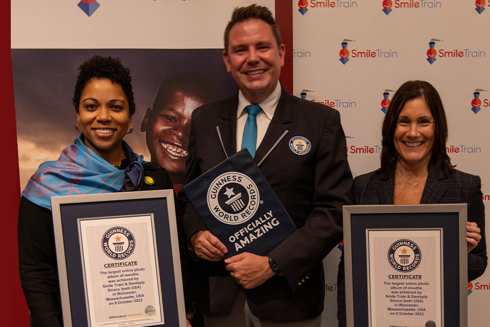 Erania Brackett and Susannah Shaefer posing with Michael Empric and their official Guinness World Records title certificates