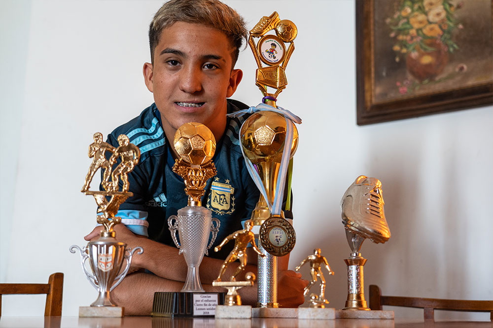 Federico smiling in the midst of his many trophies