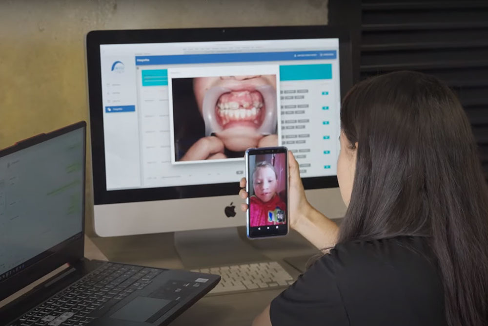 A Smile Train partner checking in with a patient remotely