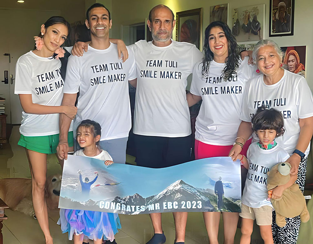 Sunil surrounded by his family, all wearing “TEAM TULI SMILE MAKER” shirts