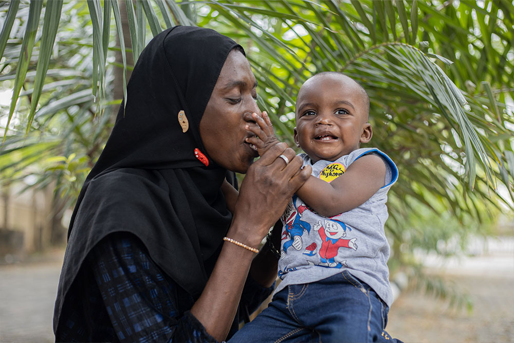 Olanike kissing Muaz’s hand after his cleft surgery