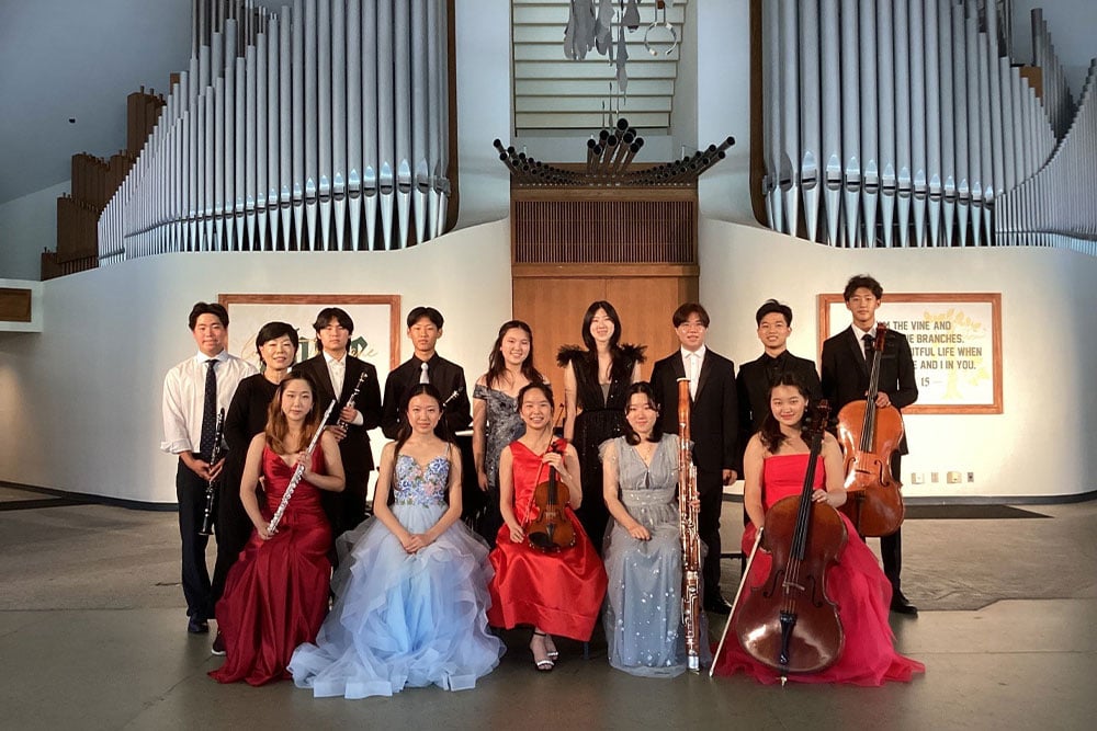 Young Sook with 2023’s performers on stage, holding their instruments