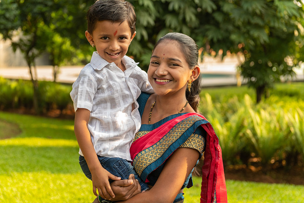 Ashwini holding Manthan and smiling