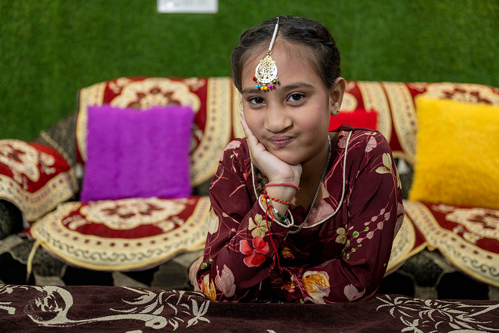 Bhumika sitting and smiling after cleft surgery