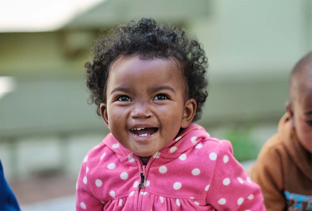 Tsiorihasina shoulders-up after cleft surgery laughing at the camera