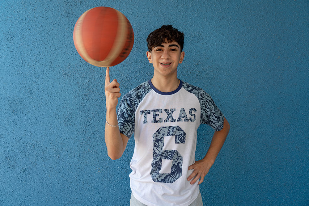 Maximiliano spinning a basketball on his finger