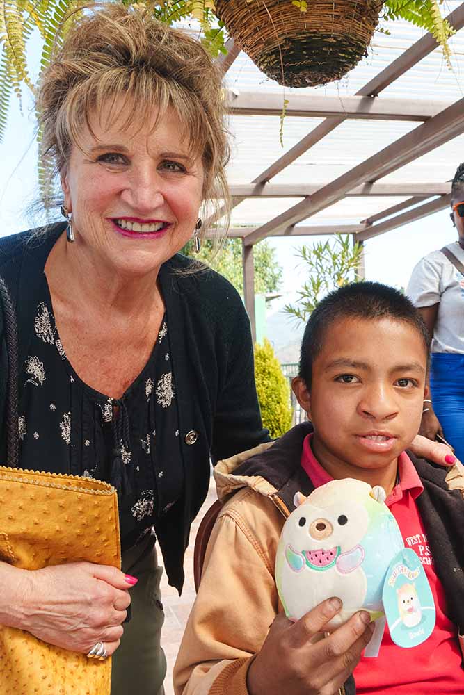 Sue Hoover smiling with a Smile Train patient