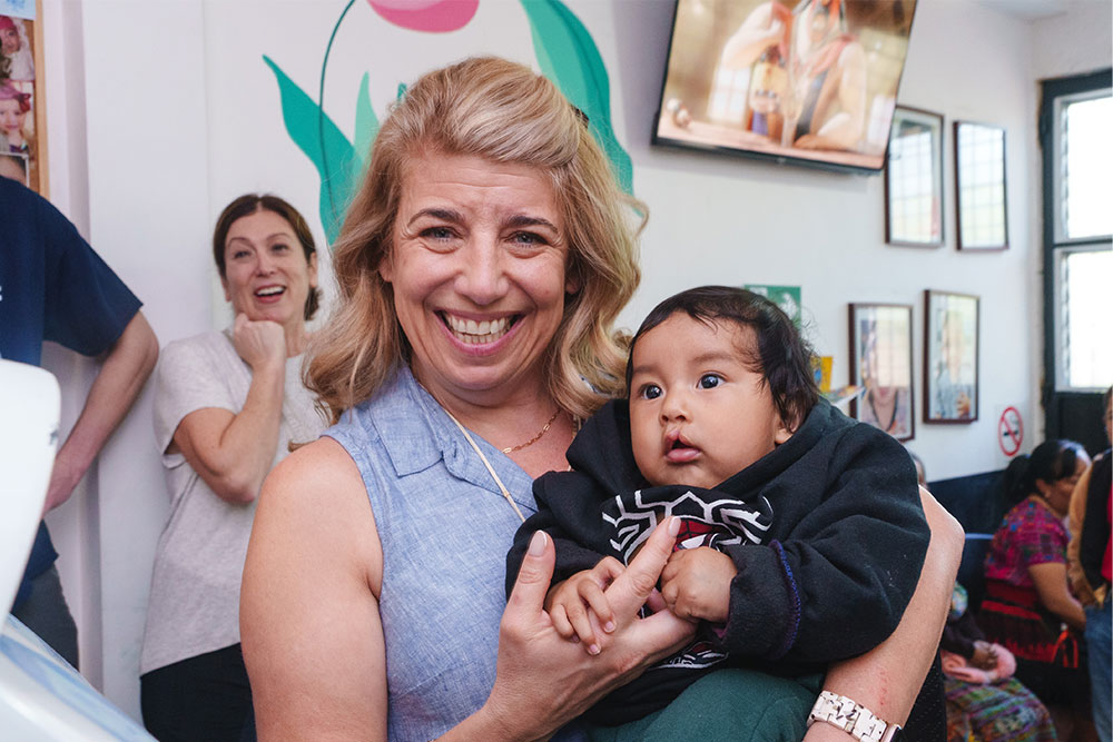 Becca holding a baby