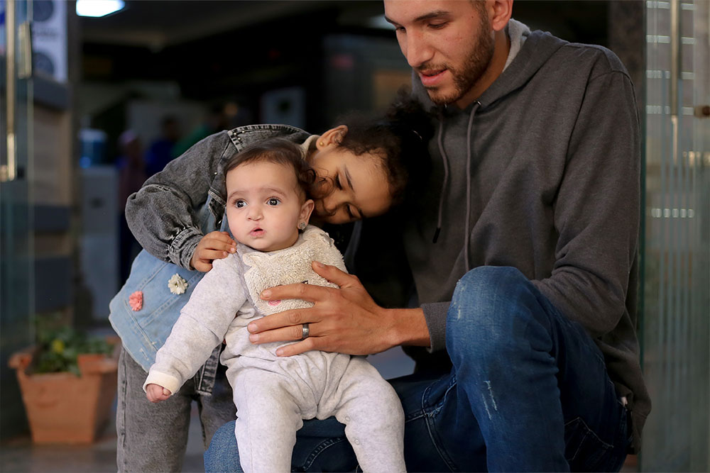 Misk being embraced by her parents