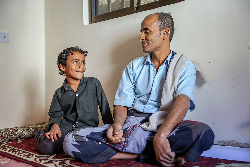 Bilal and Hael sitting and smiling together