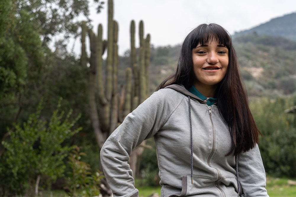 Camila standing before a cactus patch