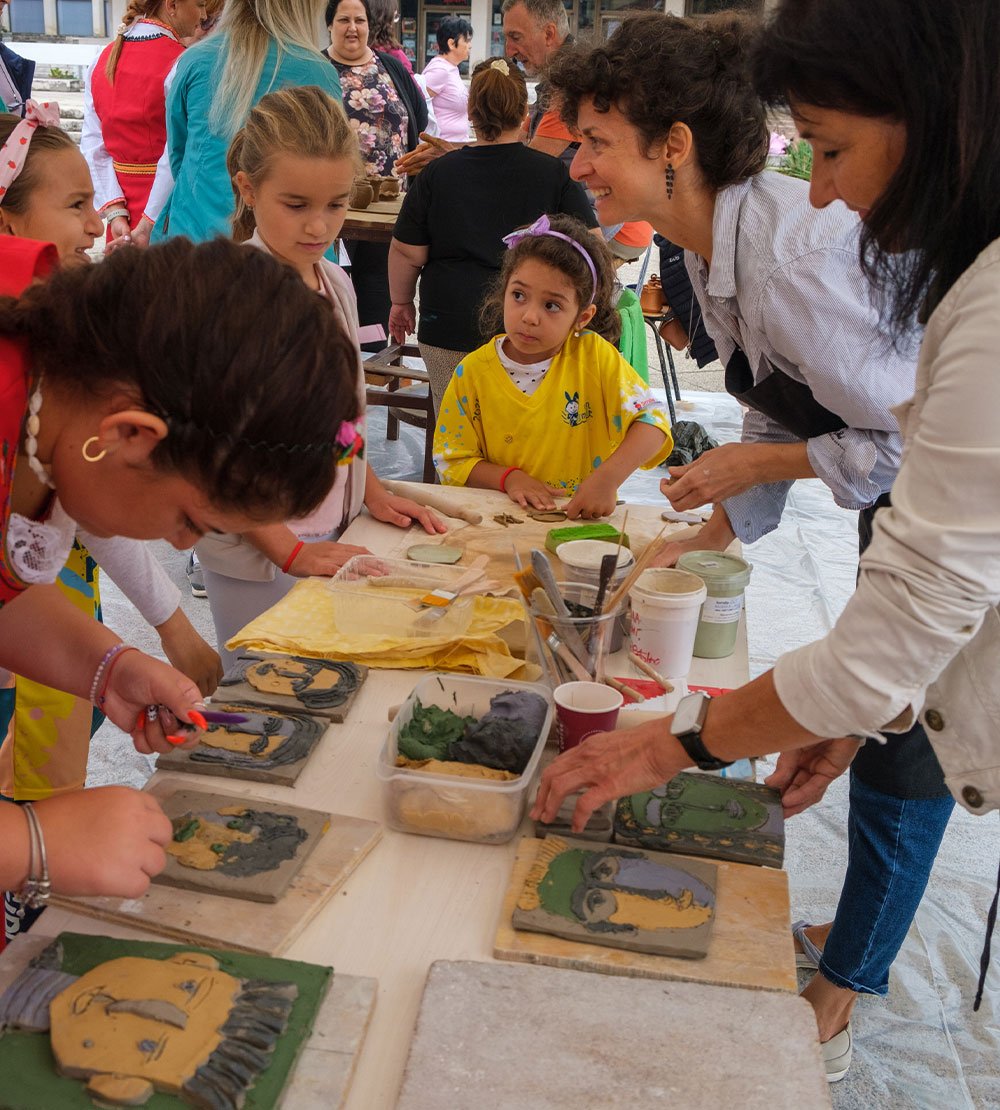Participants making faces out of ceramics