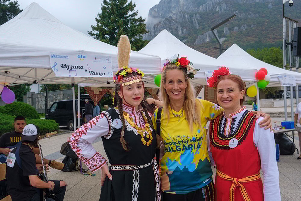Isabelle Wachsmuth flanked by women in traditional Bulgarian dress
