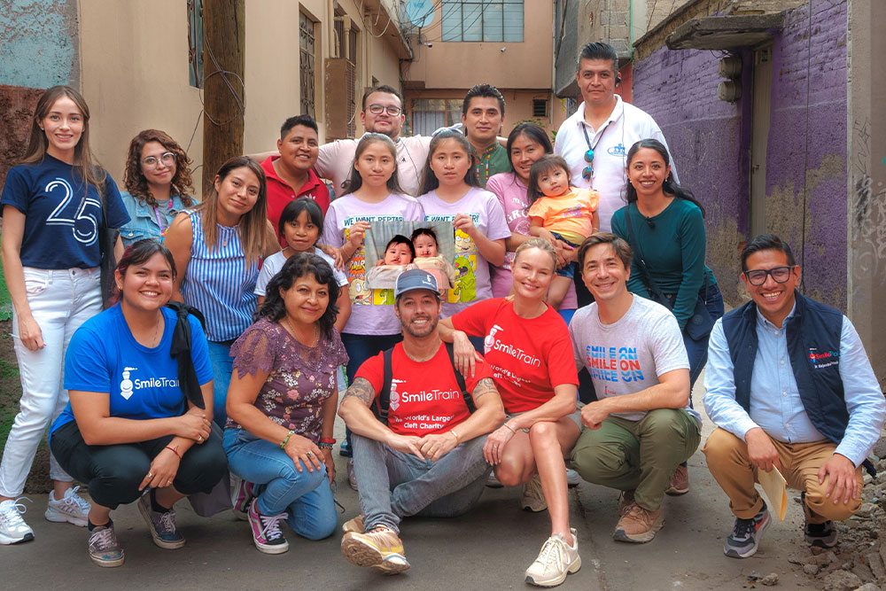 Justin Long and Kate Bosworth with Lizeth, Lizbeth, their family, Smile Train staff, partners, and others
