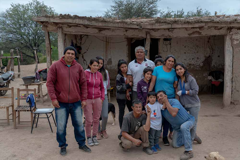 Walter gathers outside with his extended family to pose for a picture